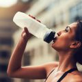 Woman drinking water after working out