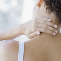 woman relieving neck pain