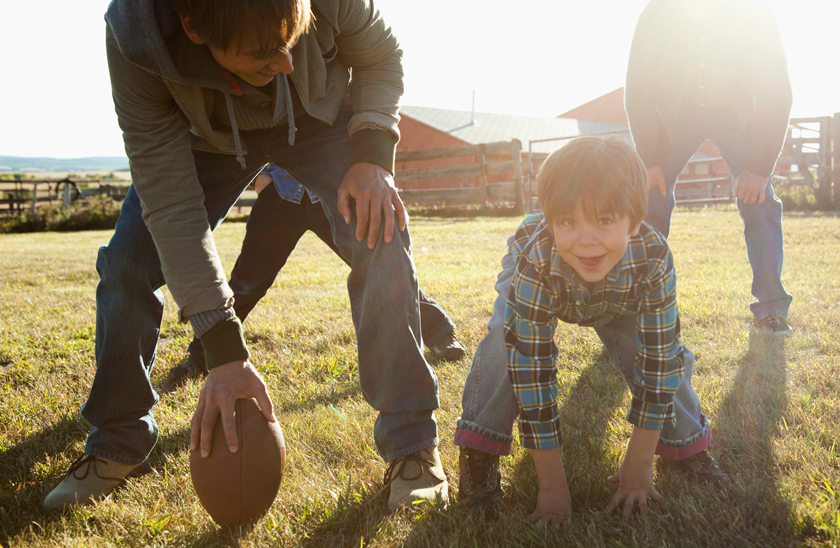 family playing backyard football