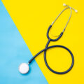 High Angle View Of Stethoscope On Colored Background