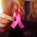 Woman Holding Out A Breast Cancer Ribbon