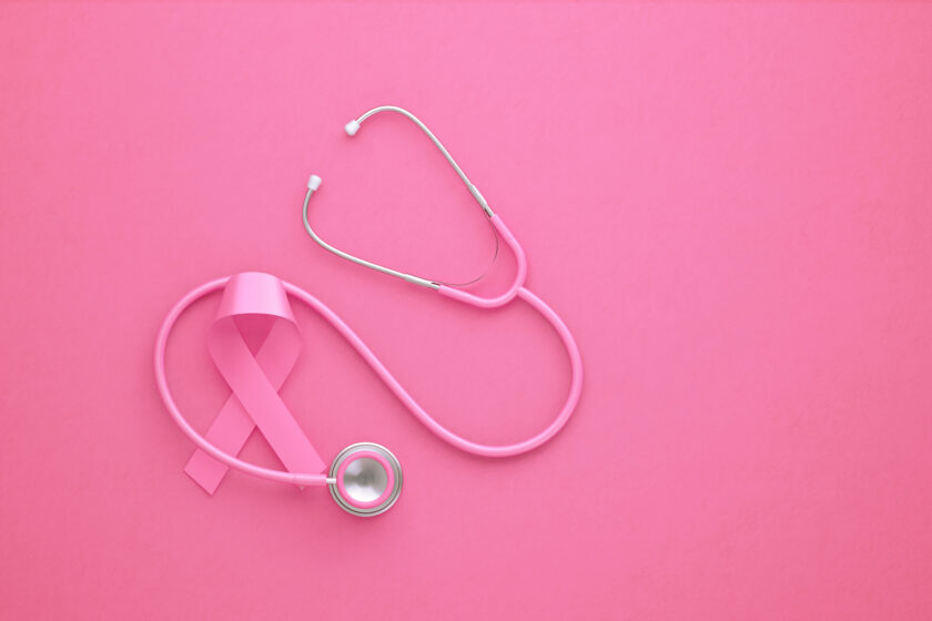Pink stethoscope and pink breast cancer awareness ribbon on pink background. Horizontal composition with copy space. Breast cancer awareness month concept.