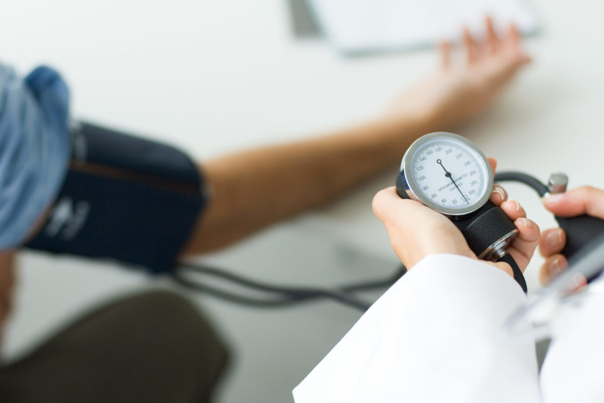 Doctor measuring patient's blood pressure, cropped view