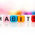 colorful word cube of habits on white background