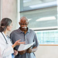 Senior man discusses care options with doctor