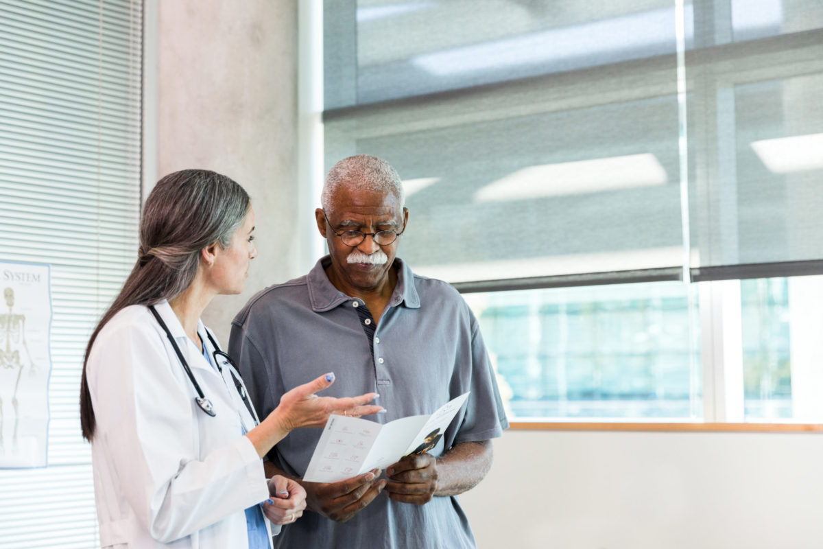 Senior man discusses care options with doctor