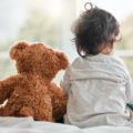 Rearview shot of a baby girl sitting at home with her teddybear