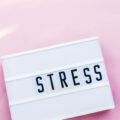 stress word in lightbox.Pink background.top view