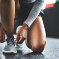 Cropped shot of a person tying their shoelaces