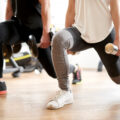 Couple doing dumbbell front lunge