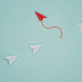 Red paper plane out of line with white paper to change disrupt and finding new normal way on blue background. Lift and business creativity new idea to discovery innovation technology. 3d render