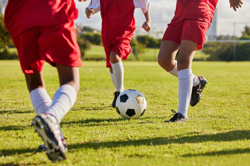 Kids playing soccer on a field