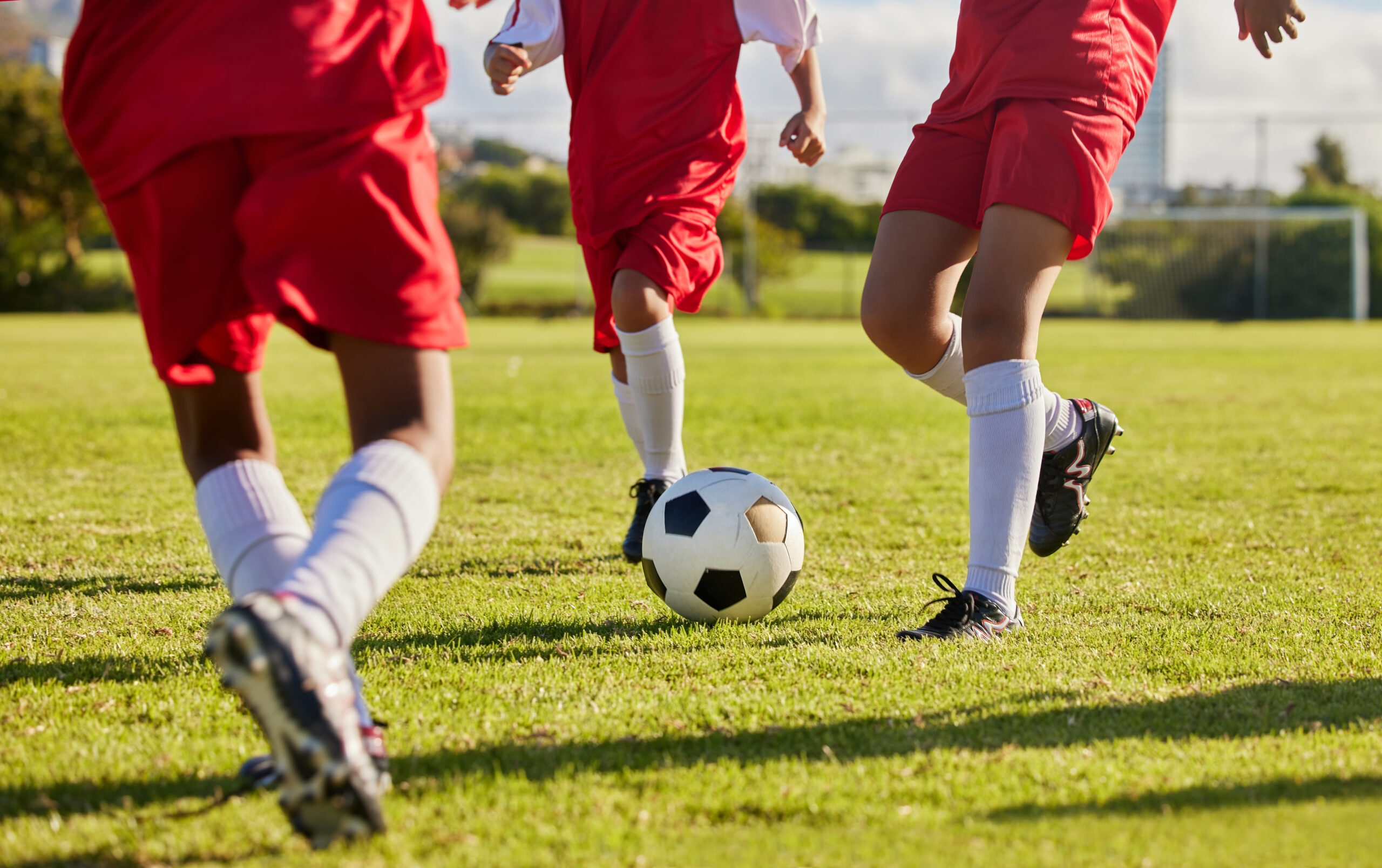 Kids playing soccer on a field