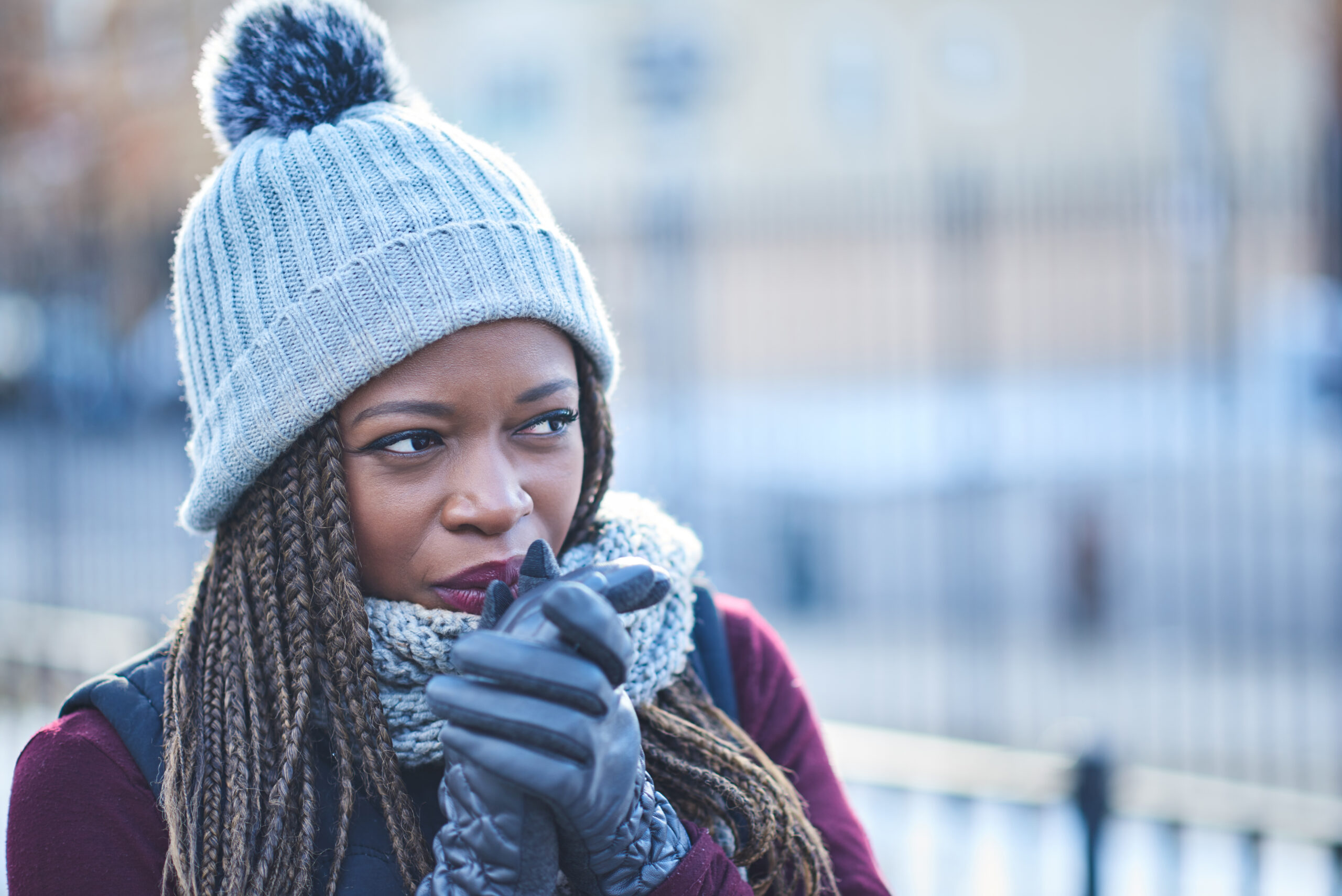 young woman looking thoughtful outside in cold weather