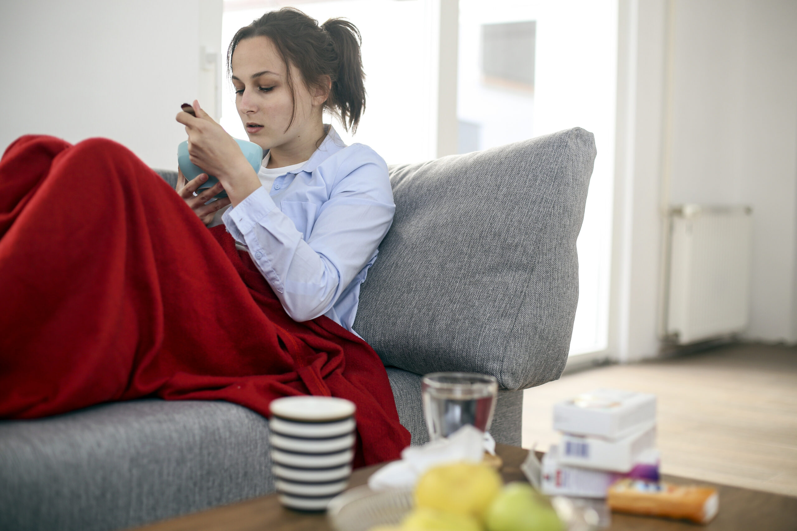 Young woman feeling sick at home.