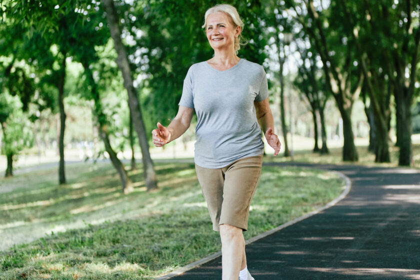 Active senior woman walking doing in the park