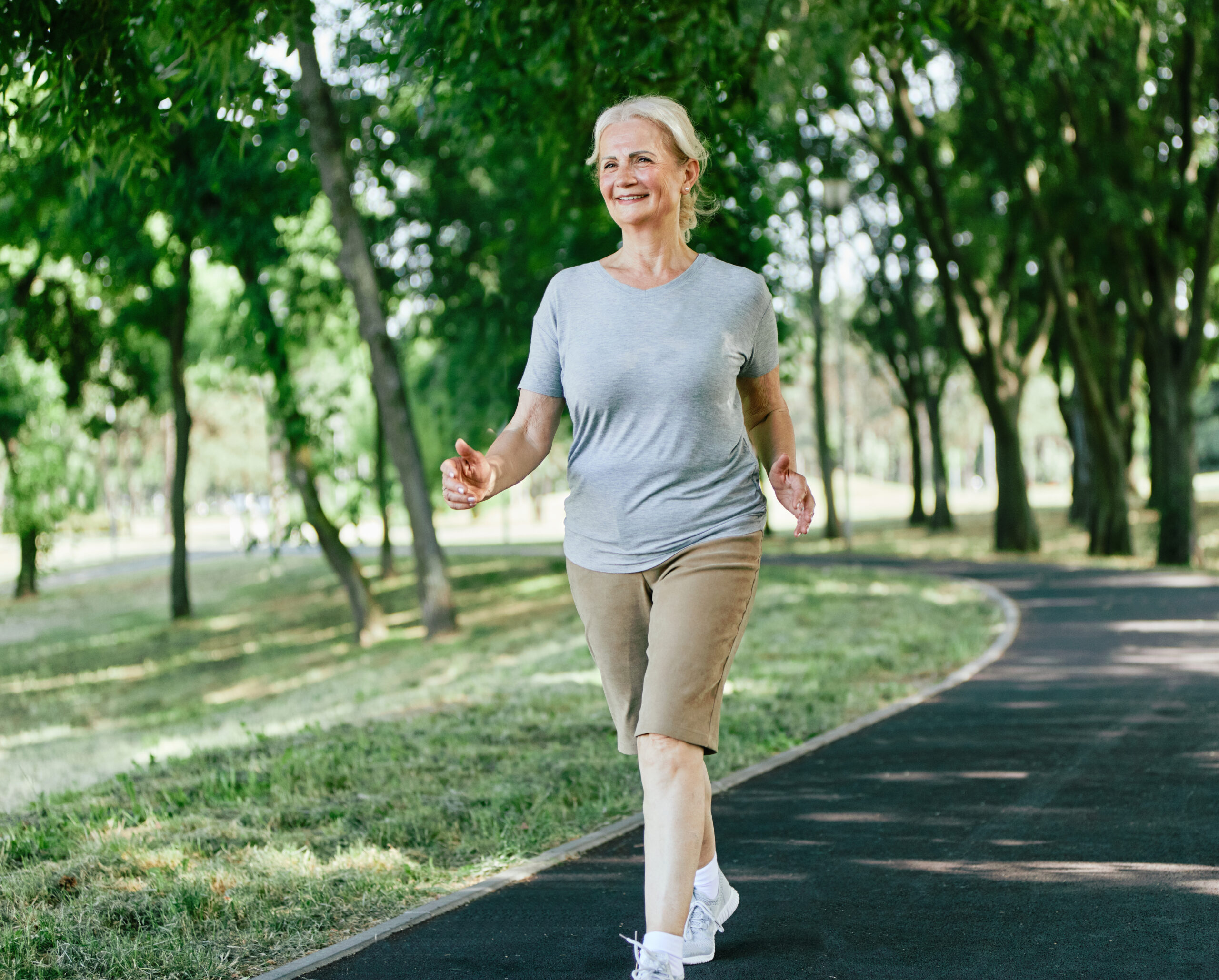 Active senior woman walking doing in the park