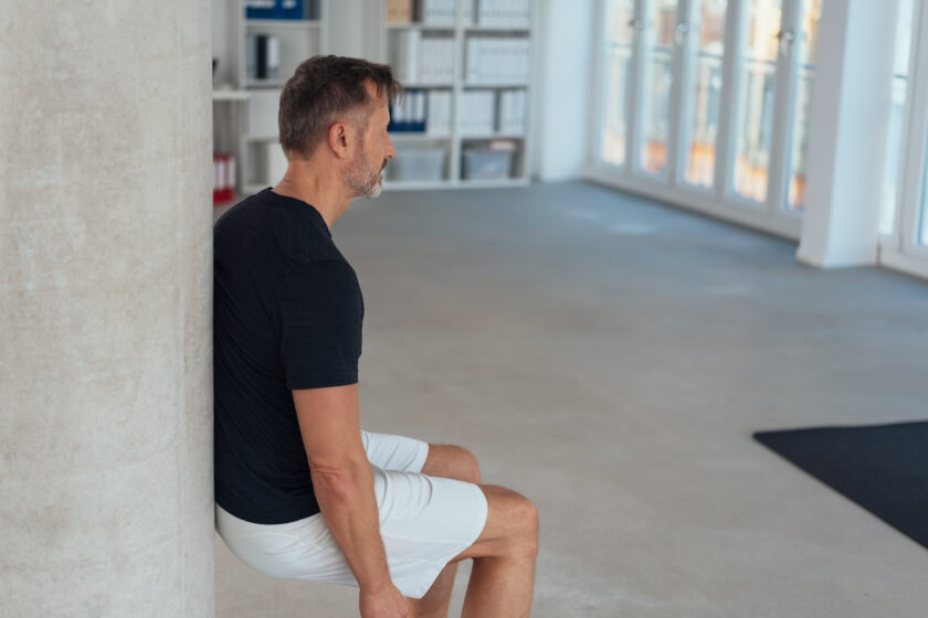 Fit healthy man doing a wall exercise