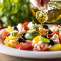 Caprese salad is oiled with olive oil.
