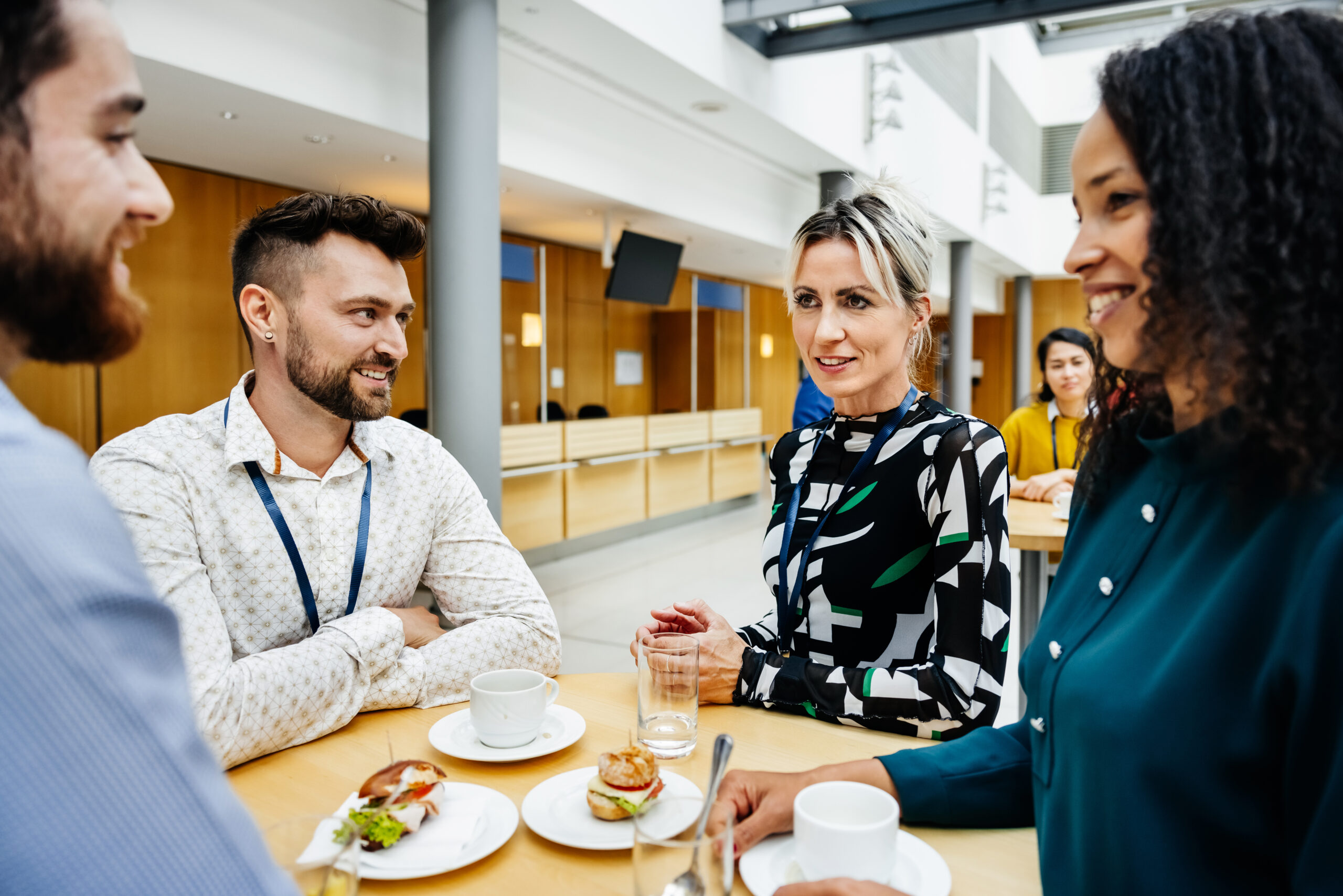 A group of people sitting down and eating lunch together.