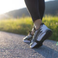 Person in running shoes on road.