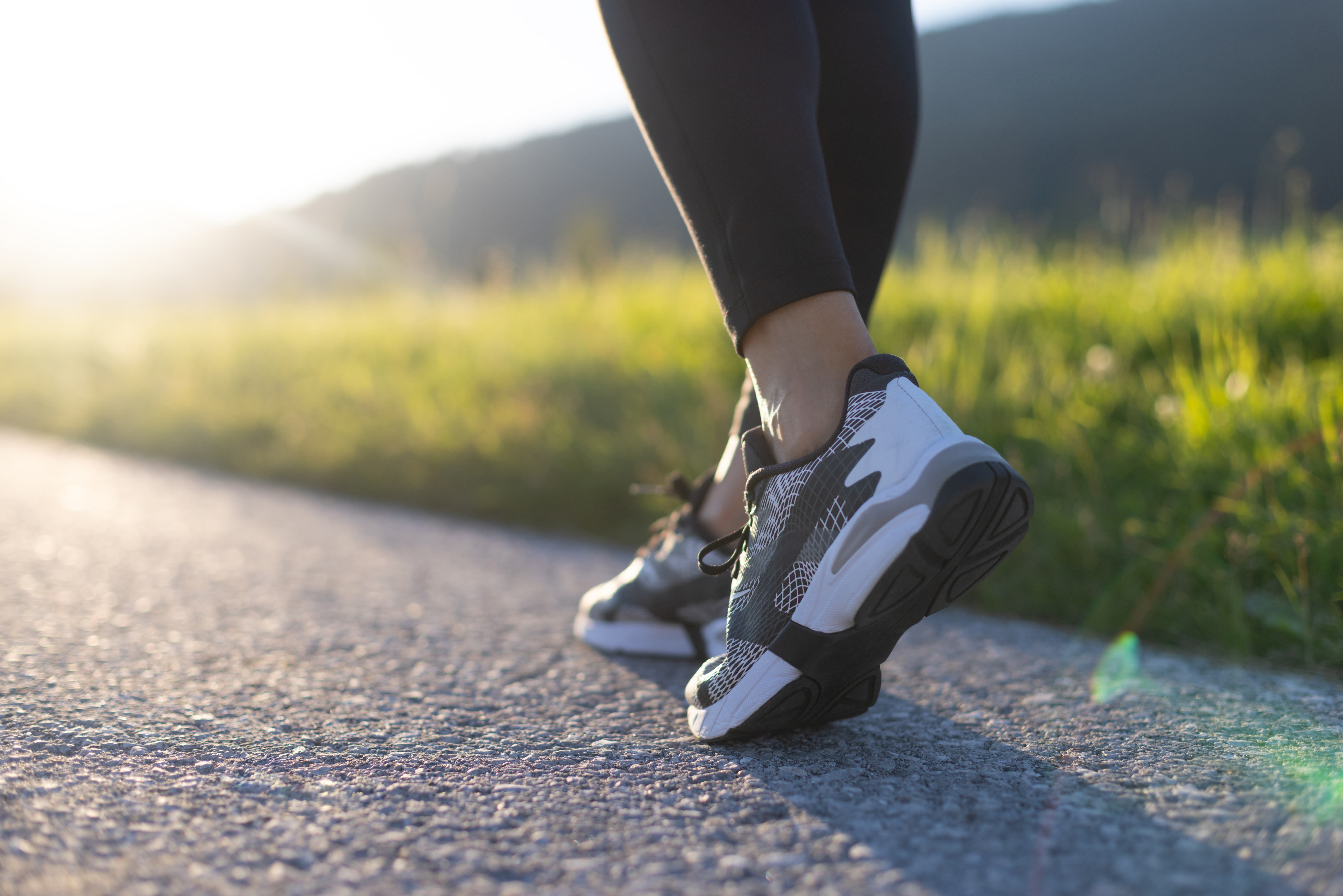 Person in running shoes on road.