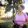 A woman running with a fitness tracker.