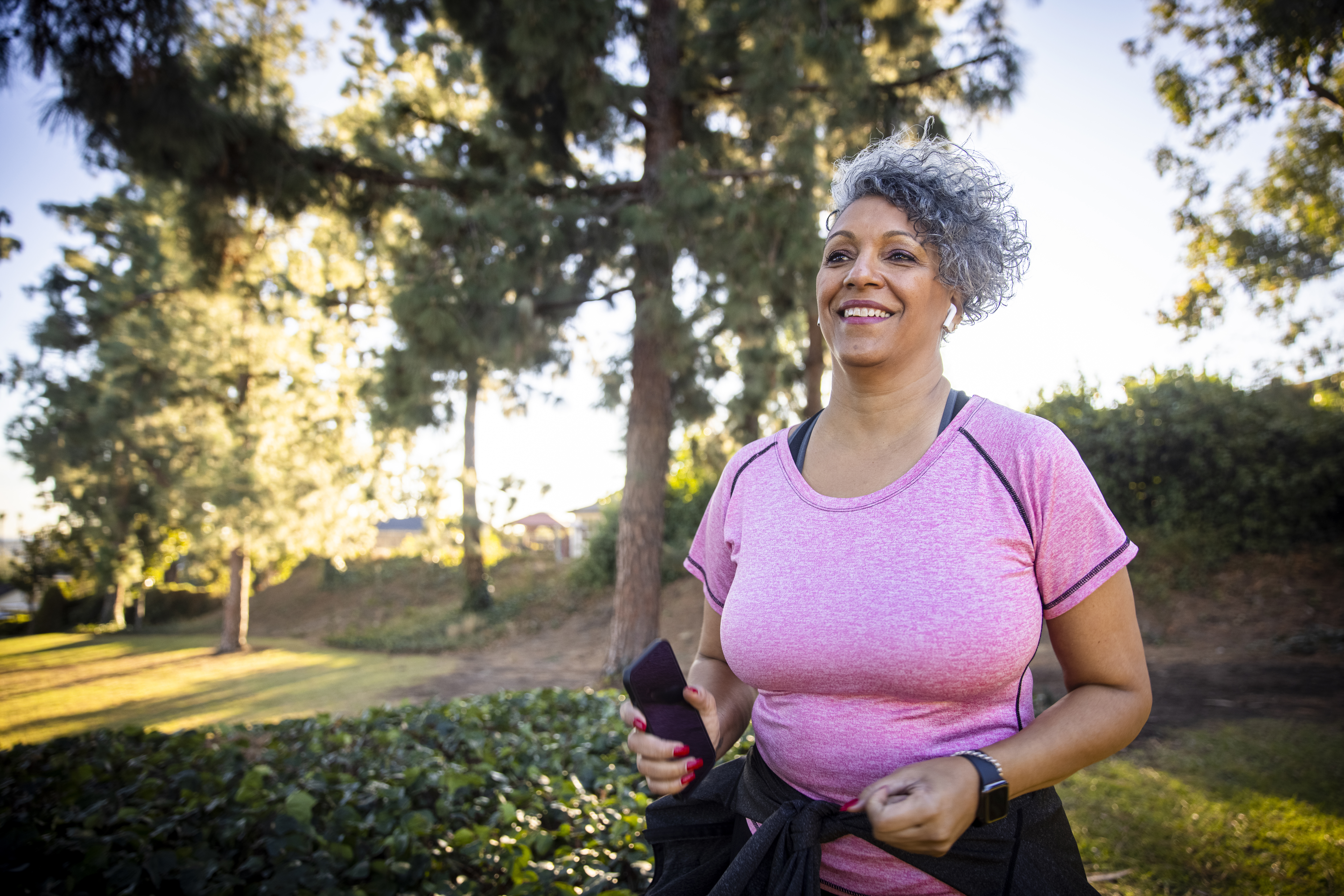 A woman running with a fitness tracker.