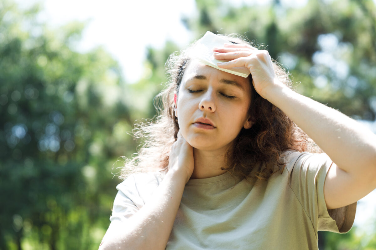 Young woman sweating in a warm summer day
