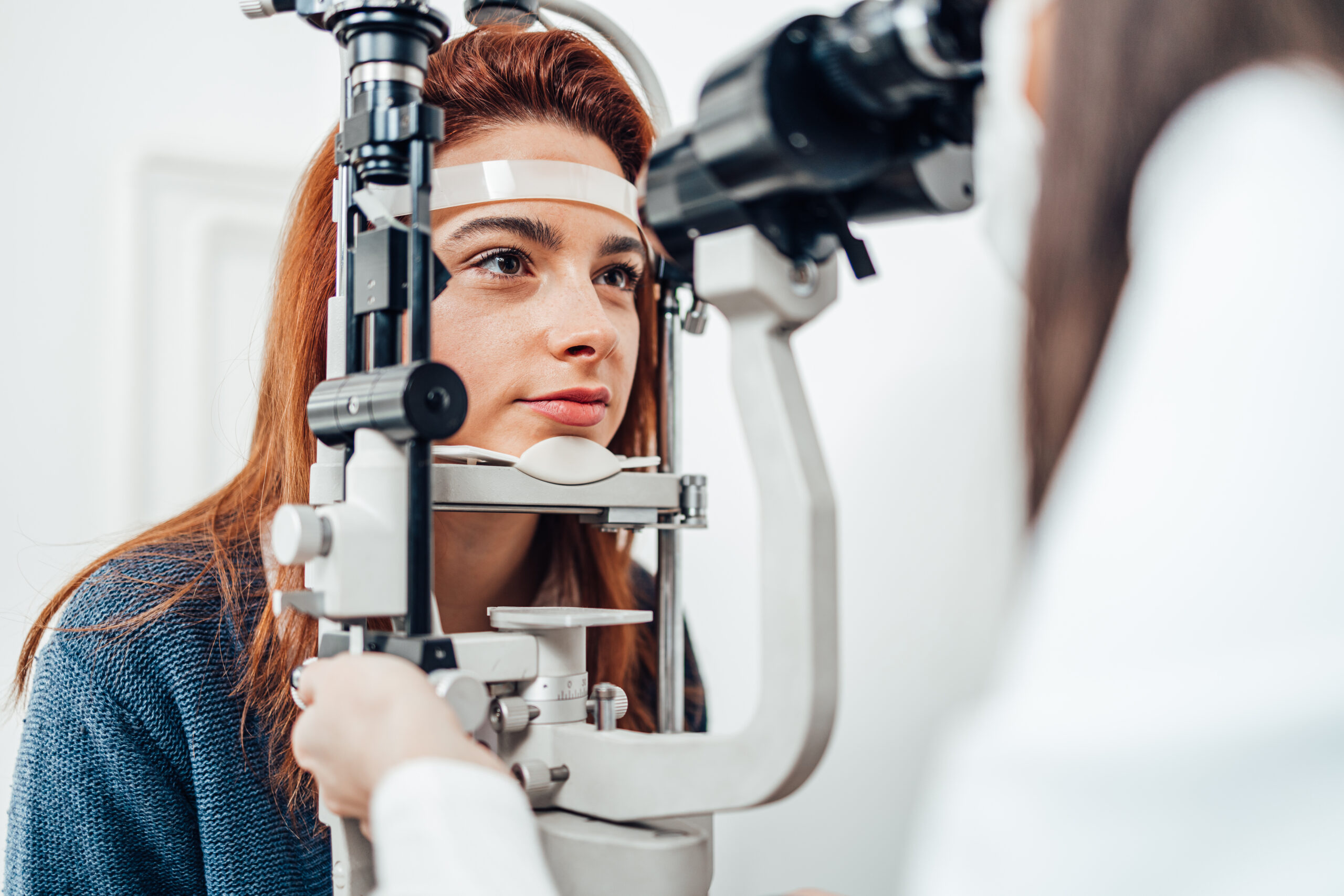 Young woman receiving ophthalmology treatment.
