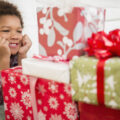 Young boy gazing at wrapped presents.