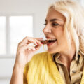 Happy woman eating chocolate