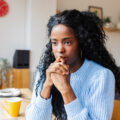 Pensive thoughtful woman with distressed mood thinking and planning.