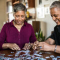 Senior couple assembling puzzle at home