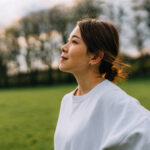Relaxed and peaceful young woman looking peacefully off into the distance.