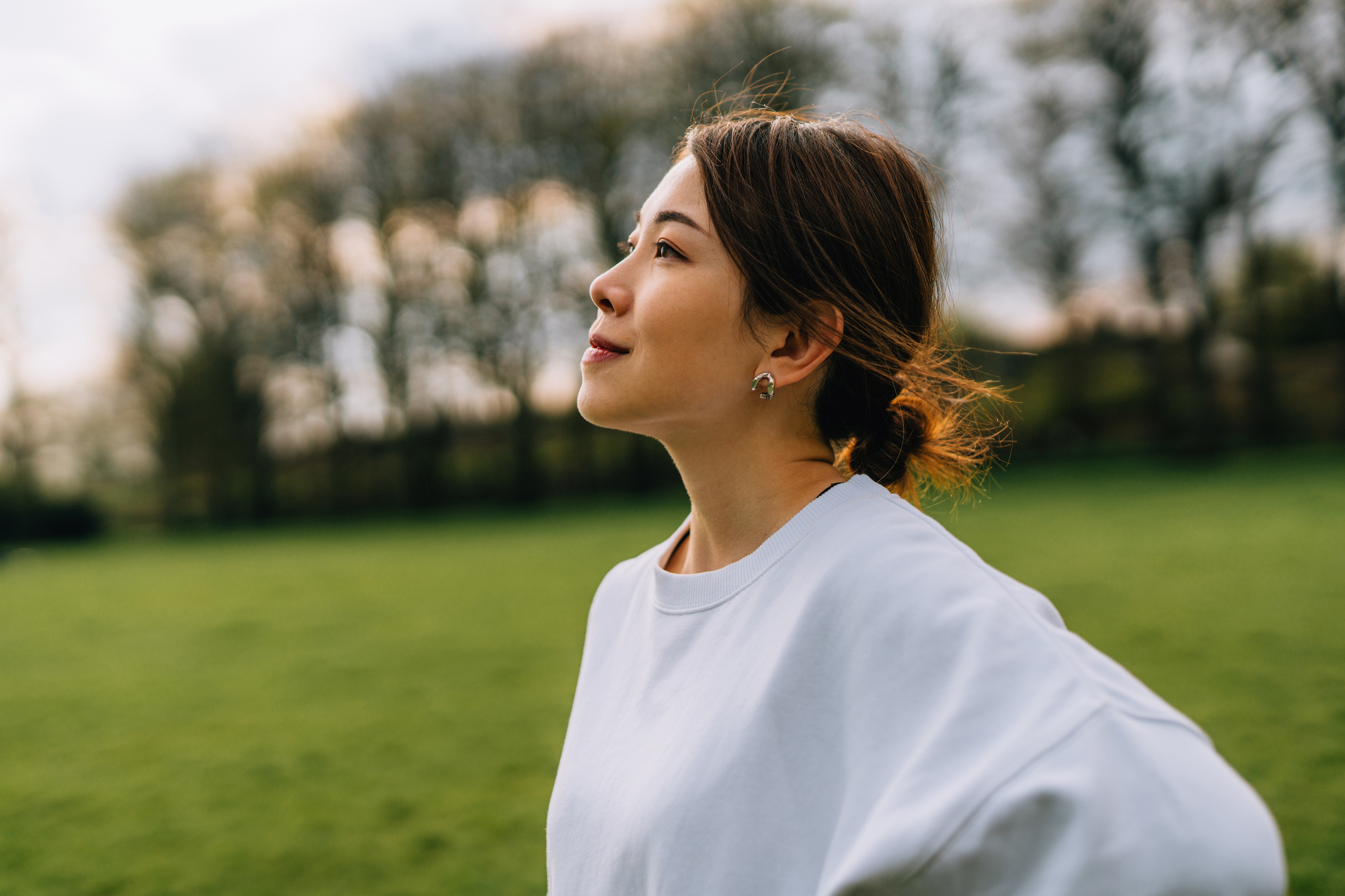 Relaxed and peaceful young woman looking peacefully off into the distance.