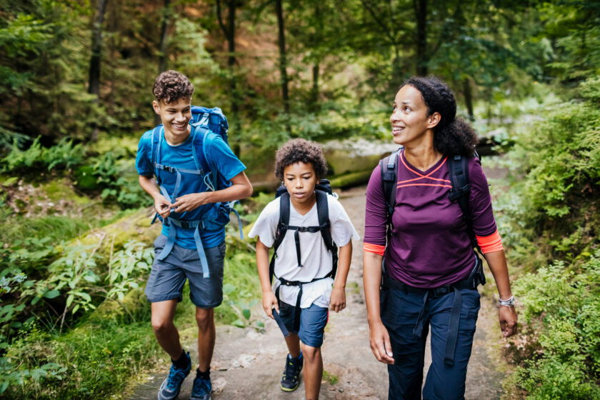 A family of three out walking a trail