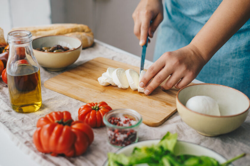 Woman cooking Caprese salad.